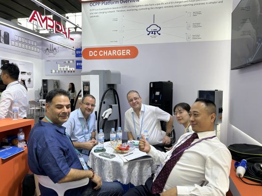 Natural Smart technical team meeting customers at an EV charging exhibition